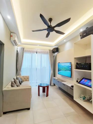 a living room with a ceiling fan and a couch at Kingfisher Sandakan in Sandakan