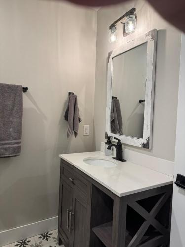 a bathroom with a sink and a mirror at Lakeside Paradise! in Brule