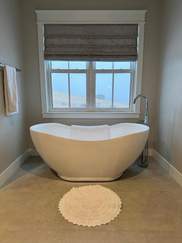 a bath tub in a bathroom with a window at Lakeside Paradise! in Brule