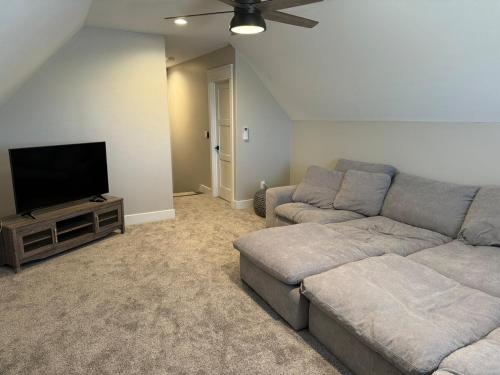 a living room with a couch and a flat screen tv at Lakeside Paradise! in Brule