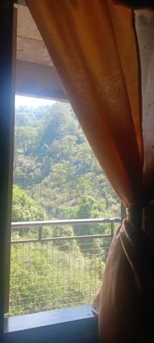 a window with a view of a mountain view at MOTHER MARRY INN in Sagada