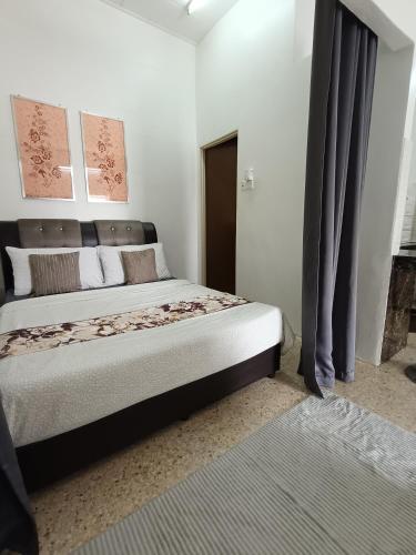 a bedroom with a large bed in a room at Canal Studio Room Kota Bharu in Kota Bharu