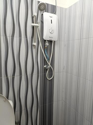 a shower in a bathroom with a shower at Canal Studio Room Kota Bharu in Kota Bharu
