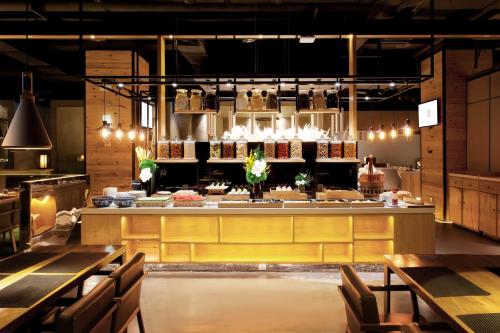 a restaurant with tables and a counter with food at Eastern House Xi'an in Xi'an
