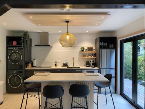 a kitchen with a large island with bar stools at Wilden Apartments in Queenstown