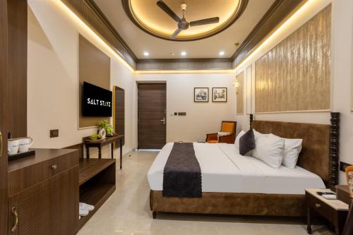 a hotel room with a bed and a large clock on the ceiling at Saltstayz Autograph - Connaught Place in New Delhi