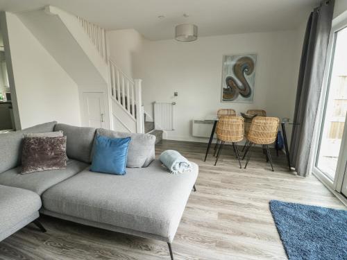 a living room with a couch and a table at 3 Parc Delfryn in Brynteg