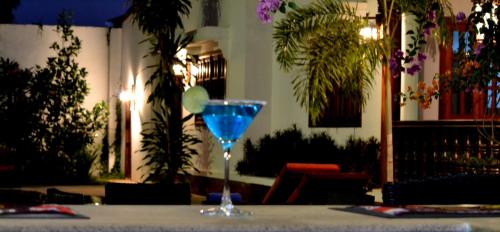 a blue glass sitting on top of a table at Eureka Villas Siem Reap in Siem Reap