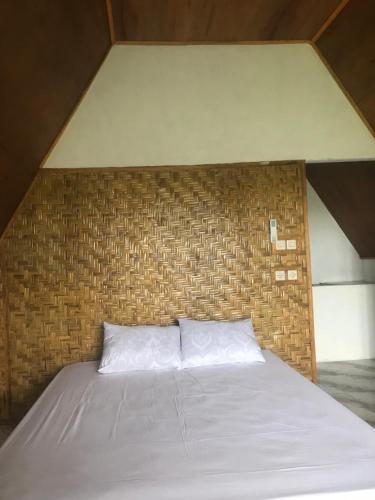 Postel nebo postele na pokoji v ubytování Bello Ethnic Bungalow & Resto