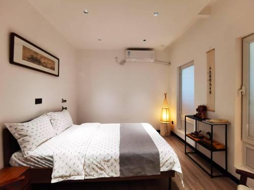 a bedroom with a white bed and a window at 华山隐泉禅境 山景观星禅修别墅 Hua Shan Hidden Spring Restore Villa in Huayin
