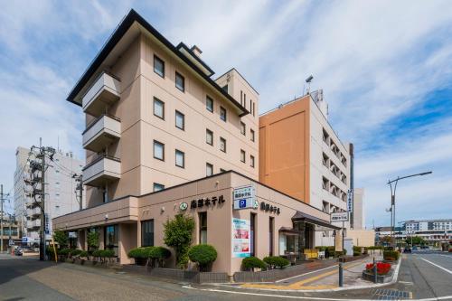 a tall building on a city street at 南部ホテル in Kitakami