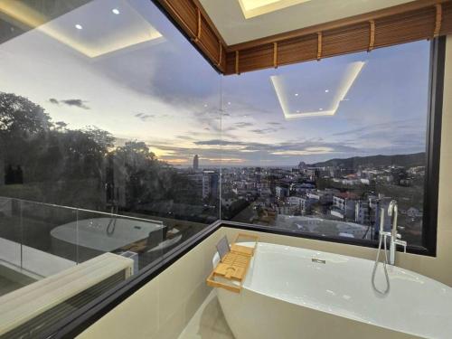 a bathroom with a large window with a bath tub and a bath tub at Luxury Seaview Villa in Patong - Villa Yona in Patong Beach