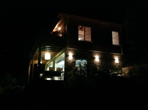 a house lit up at night with lights on it at La Villa Paille en Queue in Saint-Gilles-les-Bains