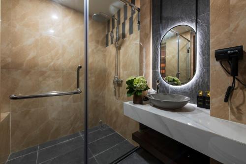 a bathroom with a sink and a mirror at Lestar Hotel Sapa in Sa Pa