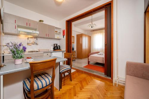 a kitchen and living room with a table and chairs at Villa Segetski dvori - Tradition since 1964 in Trogir