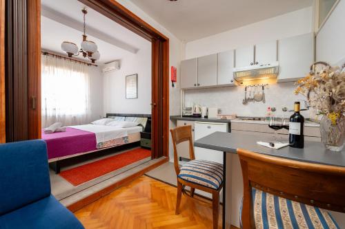 a kitchen and a living room with a bed at Villa Segetski dvori - Tradition since 1964 in Trogir