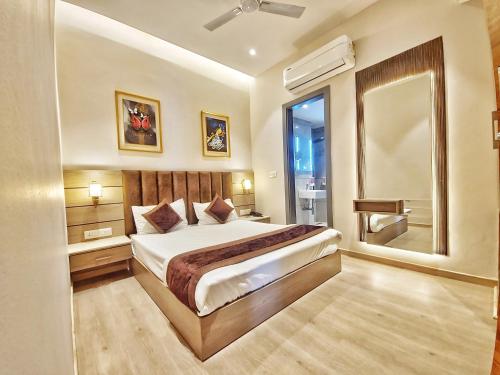 a bedroom with a large bed and a window at Hotel Maher Inn in Amritsar