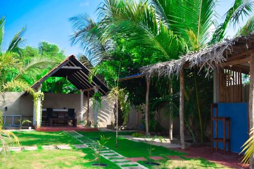 a view of a house with palm trees at Jungle View Inn in Trincomalee