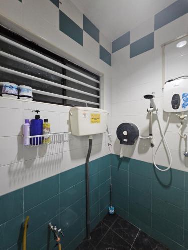 a bathroom with blue and white tiles and a shower at Warni Villa 197 Whole Or Room in Muar