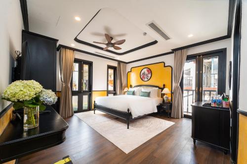 a bedroom with a bed and a ceiling fan at Yzistel Hoi An in Hoi An