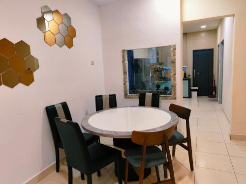 a dining room with a table and chairs at Senai three storey landed 14pax 5BR near airport in Kampung Seelung