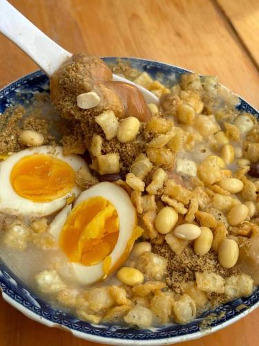 a bowl of food with eggs and beans and a spoon at Eastern House Xi'an in Xi'an