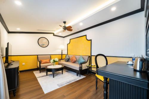 a living room with a couch and a table at Yzistel Hoi An in Hoi An
