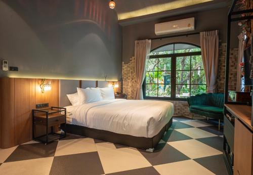 a hotel room with a bed and a window at Bangkok Oasis Hotel in Bangkok