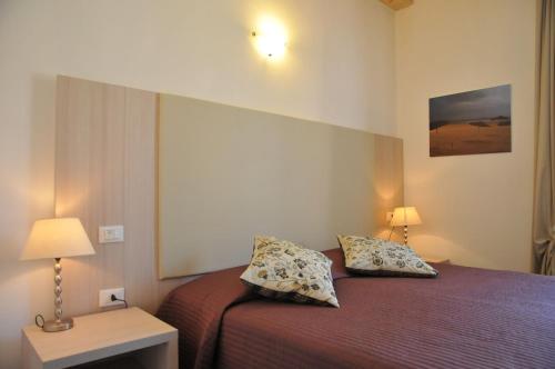 a bedroom with a bed with two pillows on it at Affittacamere Da Flo in Monterosso al Mare