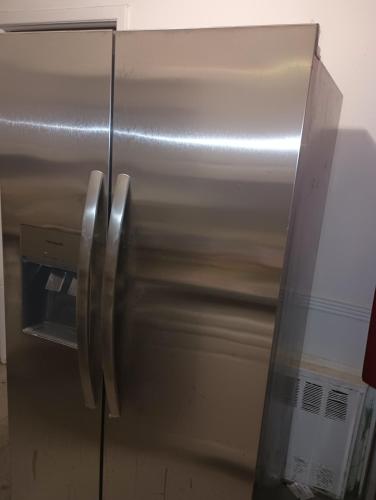 a stainless steel refrigerator with its door open at Country space in Rosedale
