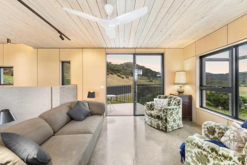 a living room with a couch and two chairs at Hill View in Myrtleford