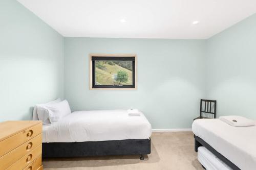 a bedroom with two beds and a dresser at Hill View in Myrtleford