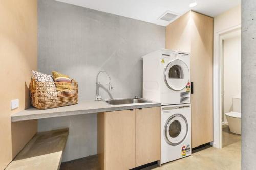 a kitchen with a sink and a washing machine at Hill View in Myrtleford