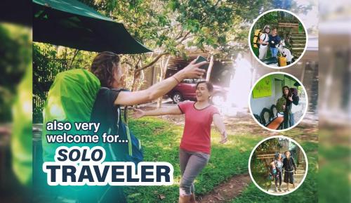 a woman taking a picture of a girl with an umbrella at Condro Wulan Hostel in Malang