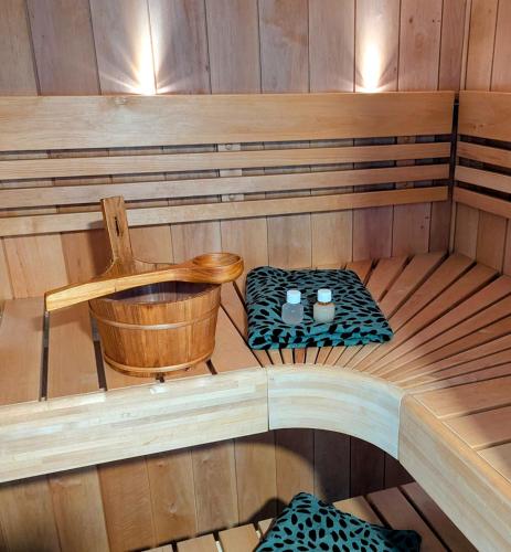 a inside of a sauna with a table and chairs at Mijn appartement met sauna en lift in Voerendaal