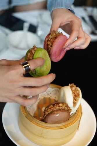 a person holding fruit on top of a cake at Eastern House Xi'an in Xi'an