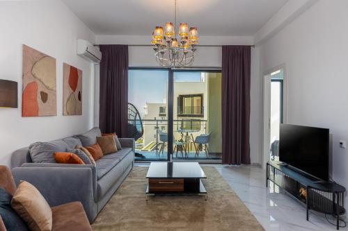 a living room with a couch and a tv at The Dream Getaway & Spa by DeVasco in Becici
