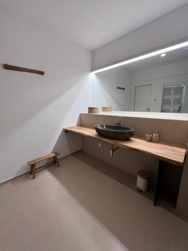 a bathroom with a sink and a mirror at Apartments-M4 in Neos Marmaras