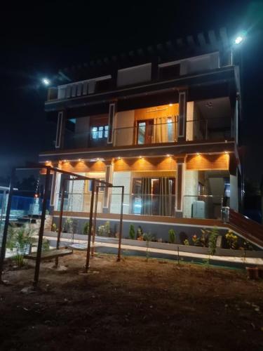 a house at night with lights on it at Little Hearts recidency in Āvadi