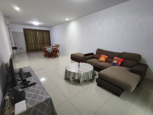 a living room with a couch and a table at Homelite Eco Park Condominium in Miri