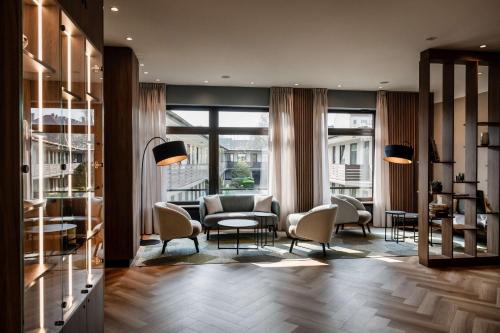 a lobby with chairs and a couch and a table at Best Western Hotel Hamburg International in Hamburg