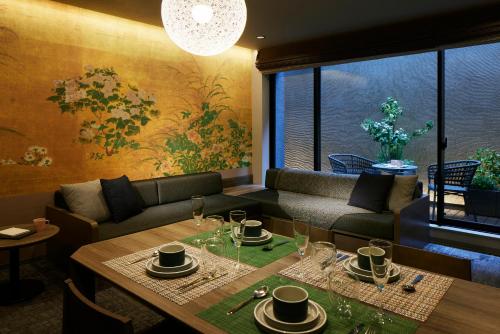 a living room with a table and a couch at Minn Gion Sanjo in Kyoto