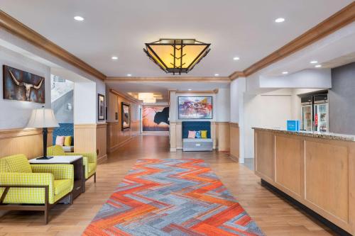 a hotel lobby with a colorful rug on the floor at Hampton Inn & Suites Dodge City Boot Hill Casino in Dodge City