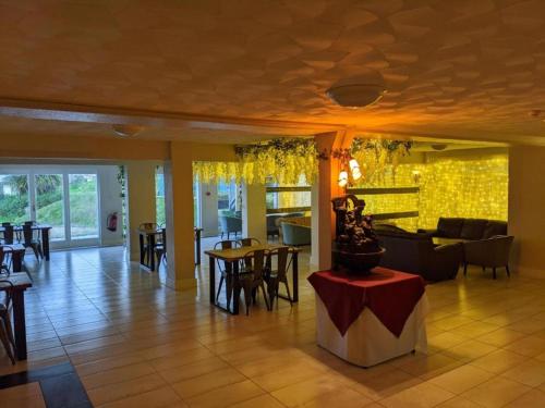 a lobby of a restaurant with tables and chairs at Mayfair Hotel - Isle Of Wight in Shanklin