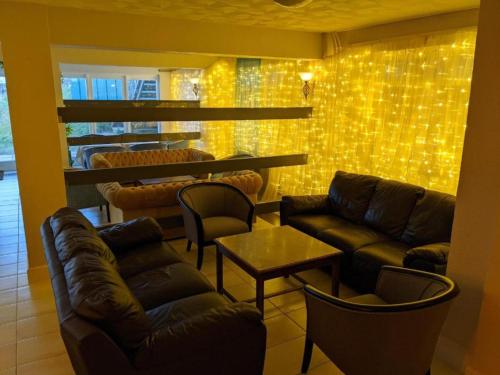 a living room with couches and chairs and a table at Mayfair Hotel - Isle Of Wight in Shanklin