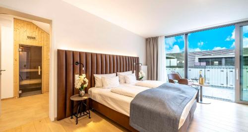 a bedroom with a large bed and a large window at Aiden by Best Western Biberach in Biberach an der Riß