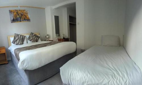 a hotel room with two beds in a room at Mayfair Hotel - Isle Of Wight in Shanklin