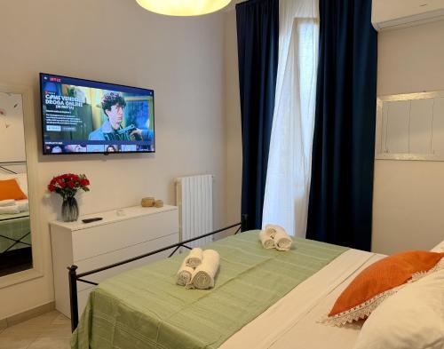 a bedroom with a bed with two towels on it at AGATHEA APARTMENT - Central Location, Just 50m from the Sea - Nettuno in Nettuno