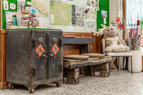 a room with a desk and a table with a stuffed animal at Forever Happiness Hostel in Puli