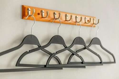 a group of hangers hanging on a wall at Forever Happiness Hostel in Puli